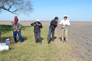 Team members using t-probes in the field.