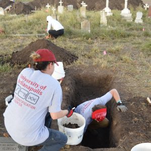 Two team members excavating a burial.