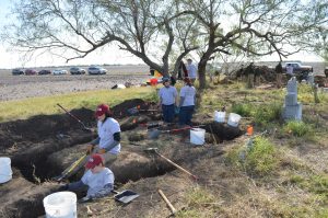 Overview of team members digging trenches.