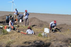 Overview of team members digging trenches.