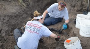 Dr. Latham and Jessica excavating a burial.