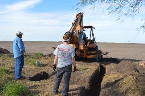 Dr. Latham watching the backhoe.