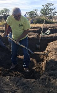 Eddie Canales helping excavate a burial.