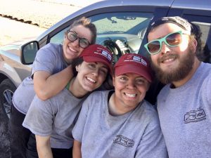 Leann, Sammi, Jessica, and Jordan smiling and dirty after a day of work.