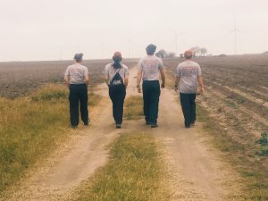 Team members walking down a dirt road.