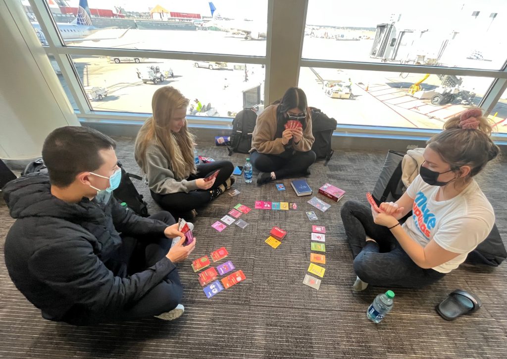 Beyond Borders Team playing a card game at the airport