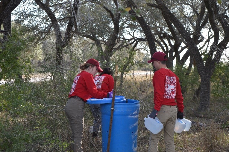 Team members filling a water station 