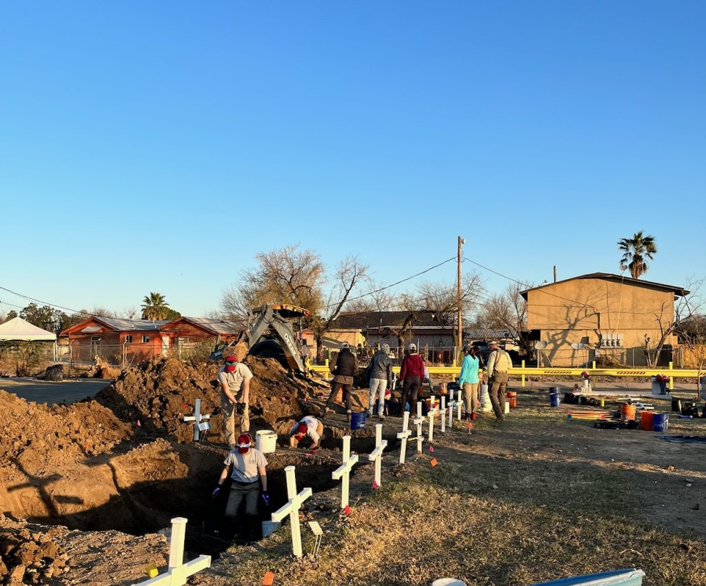 Team members working at the cemetery to locate and uncover burials