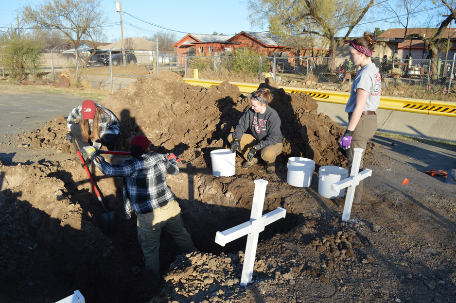 Team members digging at the cemetery 
