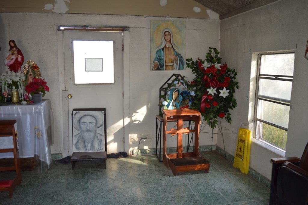 Don Pedrito Shrine with alters, crosses, and flowers. 