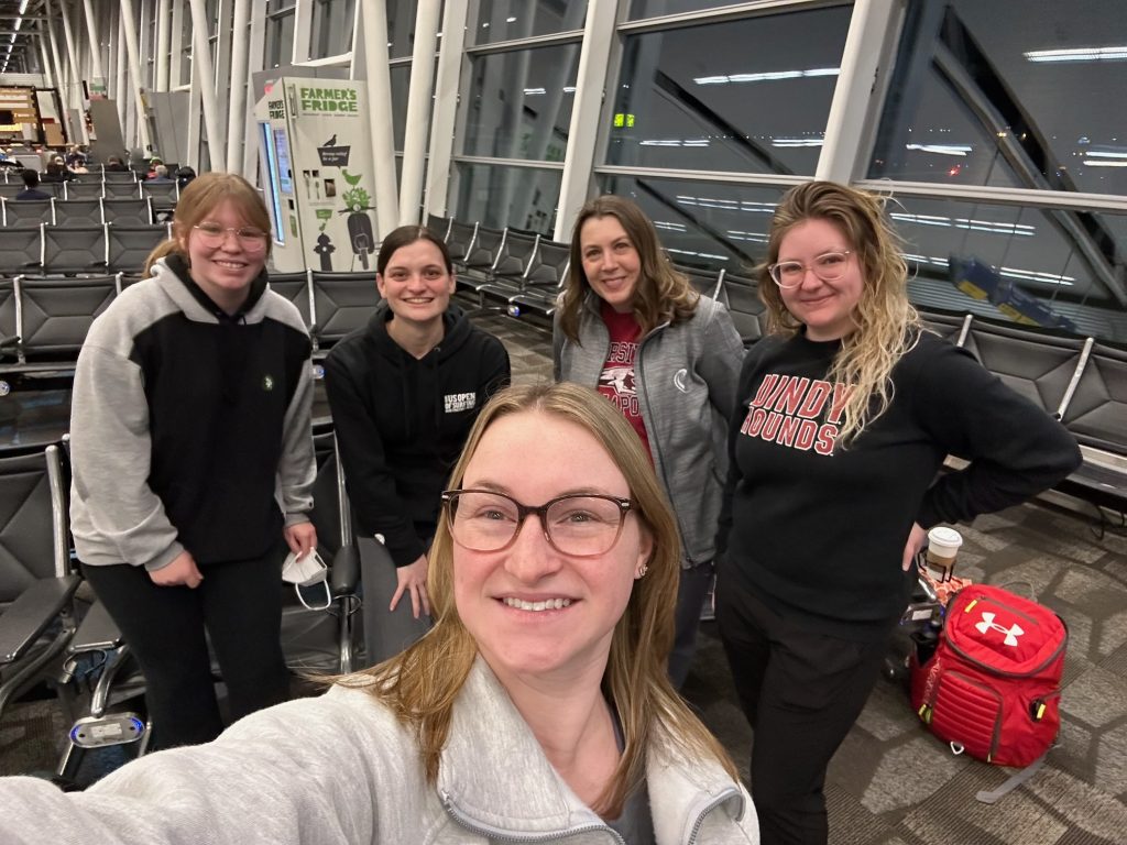 The team in the Indianapolis Airport ready to head to Texas.  In the front row is Hannah, and behind her from left to right is Ella, Claire, Dr. Latham, and Chastidy.