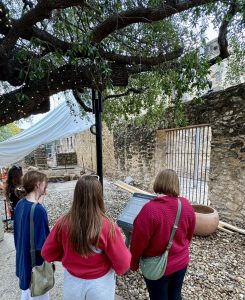 Students reading about the archaeology projects at the Alamo