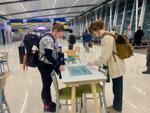 Students playing games at the airport