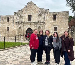 Team Members standing in front of the alamo