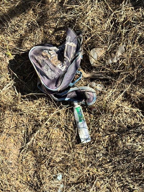 Backpack left in the brush with personal items