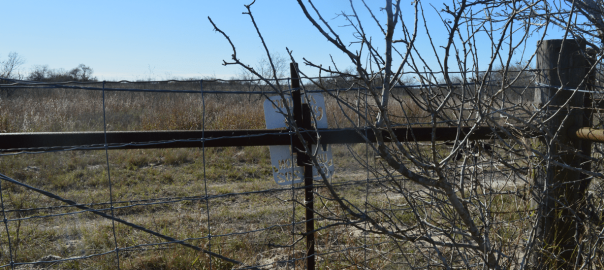 Fence with 911 emergency sign.